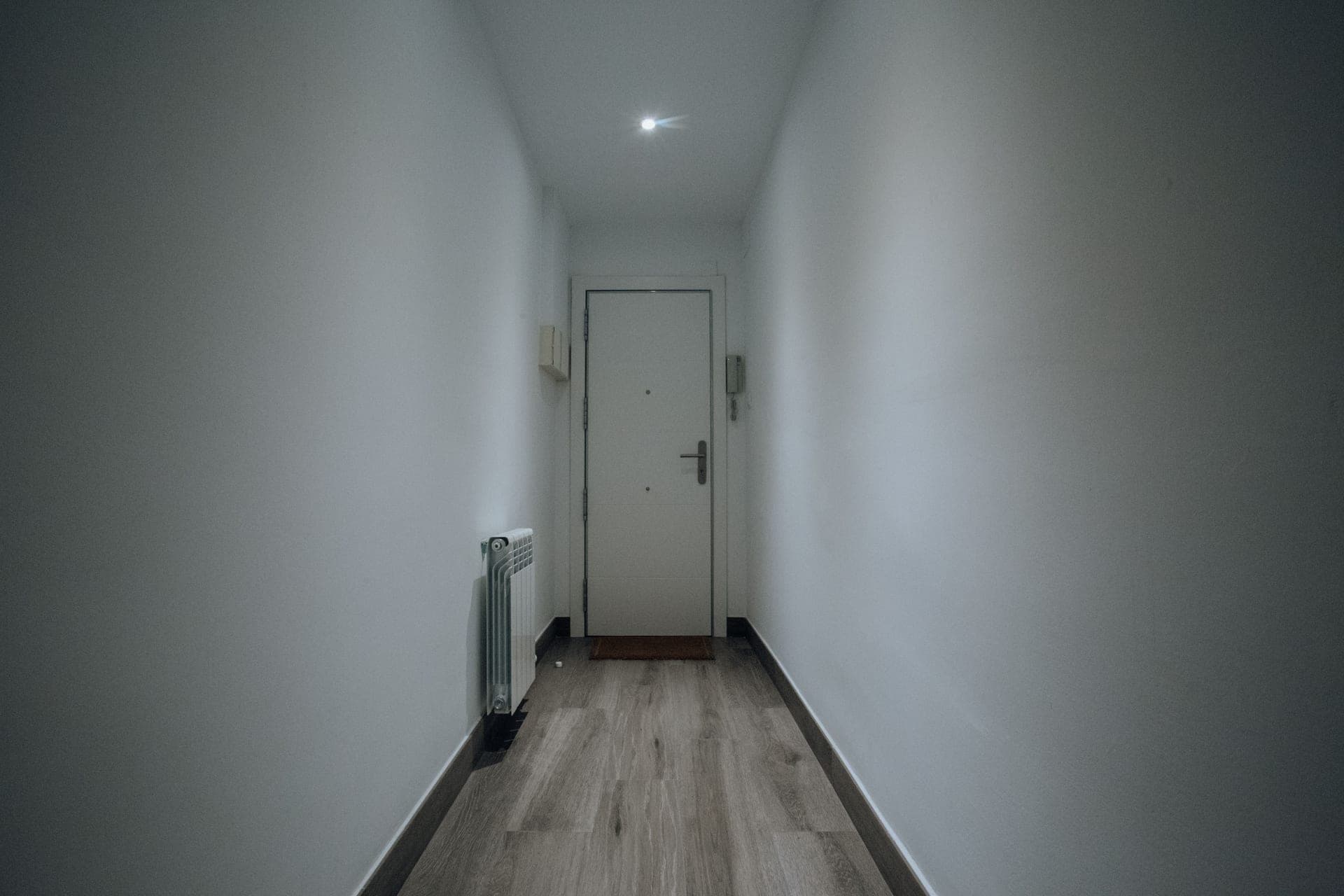 A closed white interior door in a hallway