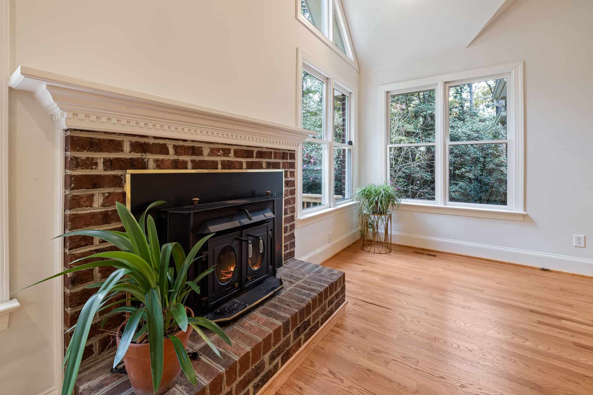 A brick fireplace with a raised hearth in a living room