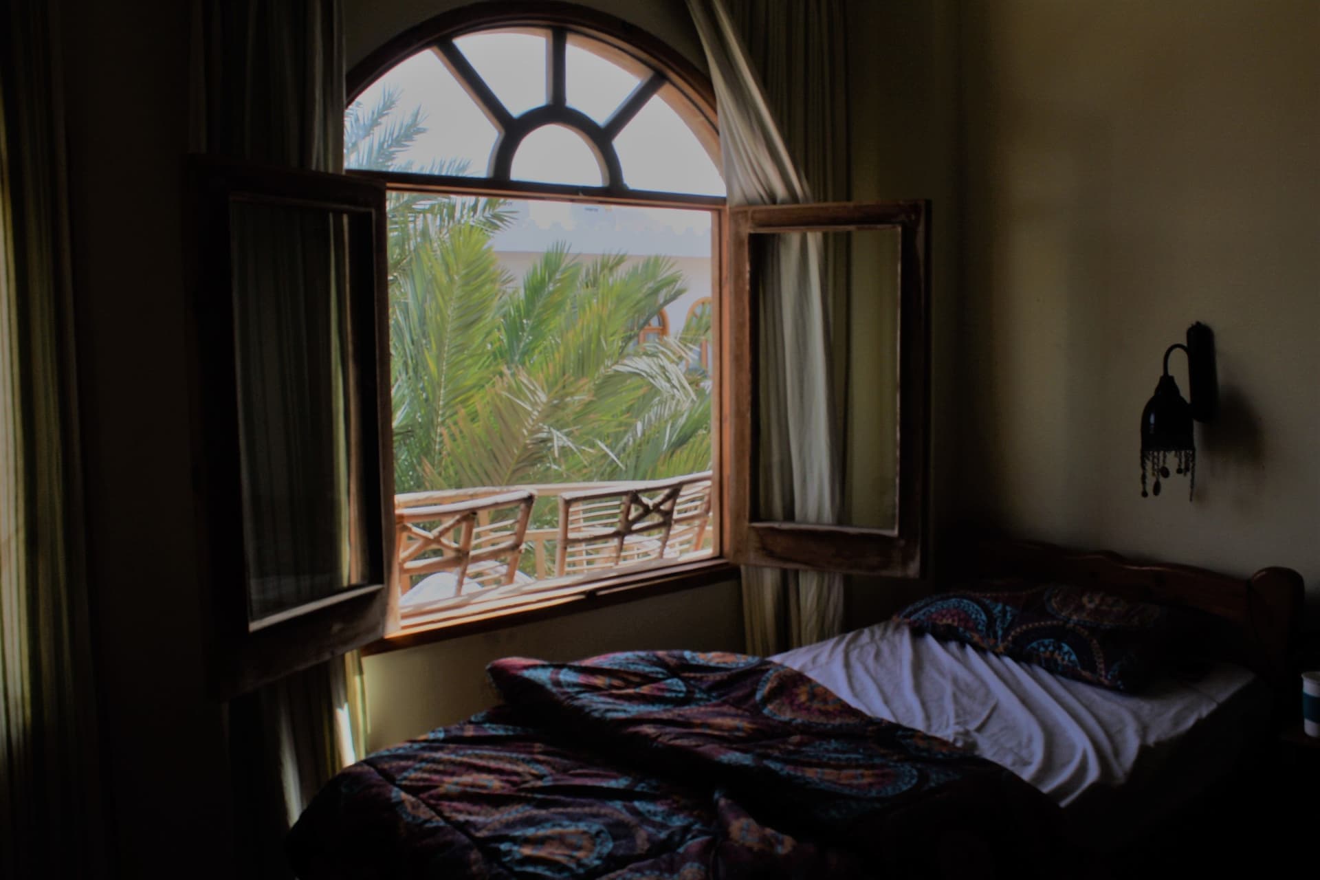 An open window with a white frame in a bedroom
