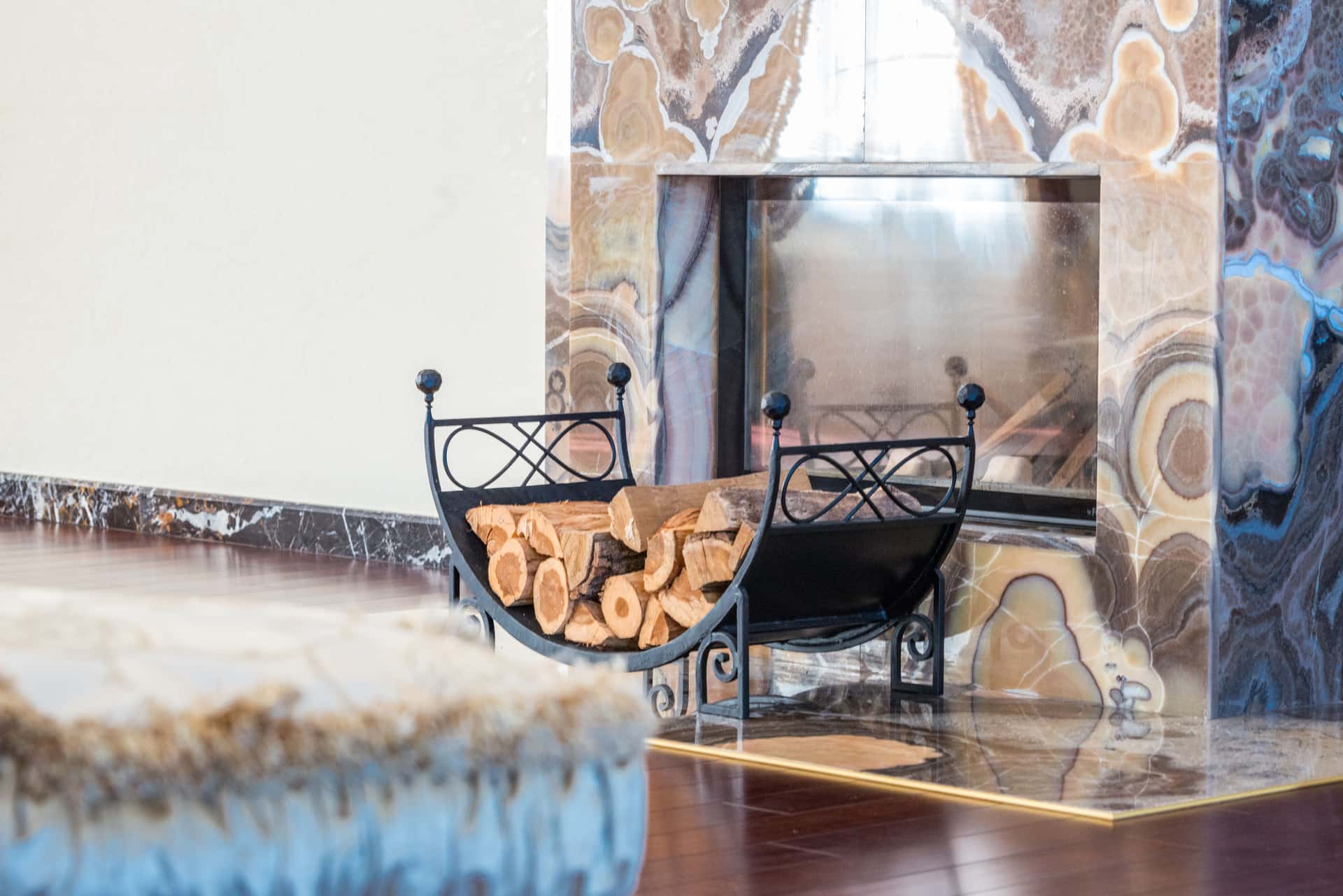 A black metal screen standing in front of a fireplace